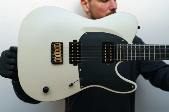 Aristides T/0 Ivory Pearl Satin equipped with @bareknucklepickupsofficial Polymaths, hybrid hardware and a black pickguard!