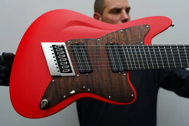 Aristides STX8SR Bright Red loaded with @bareknucklepickupsofficial Halcyons, Brown Flamed Marble pickguard, and our multiscale @evertune in Brushed Chrome!