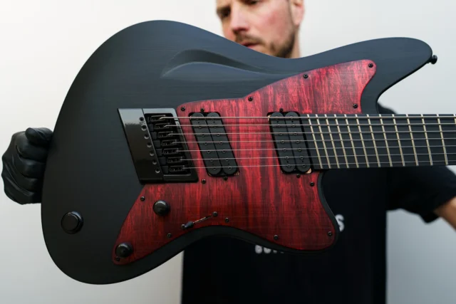 Aristides STX7SR Black with an Oxblood Flamed Marble pickguard with @lundgrenguitarpickups M series bridge / Black Heaven neck pickup as well as a multiscale @evertune