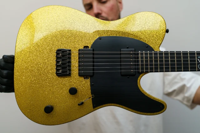 Aristides T/0 Gold Sparkle with a black raw pickguard and the Seymour Duncan SH-4/SH-2 set!