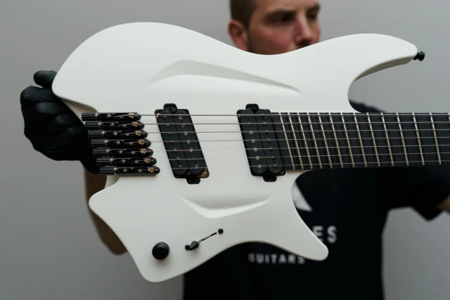 Aristides H/07R White featuring scalloped upper frets, a white raw painted backplate, and a custom slanted Seymour Duncan Pegasus/Sentient set!