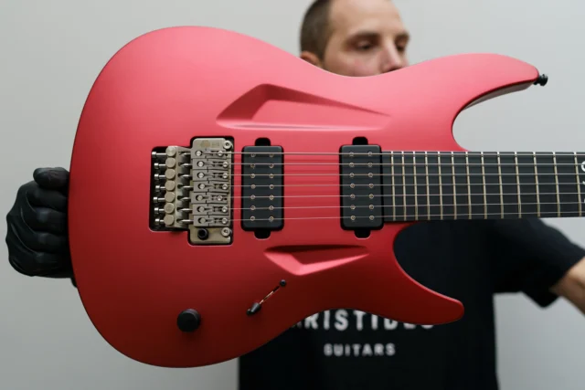 Aristides 070 Red Metallic Satin loaded with a very special @kissmystrings Titanium double-locking tremolo, as well as @dimarzioinc Evolution 7 pickups!