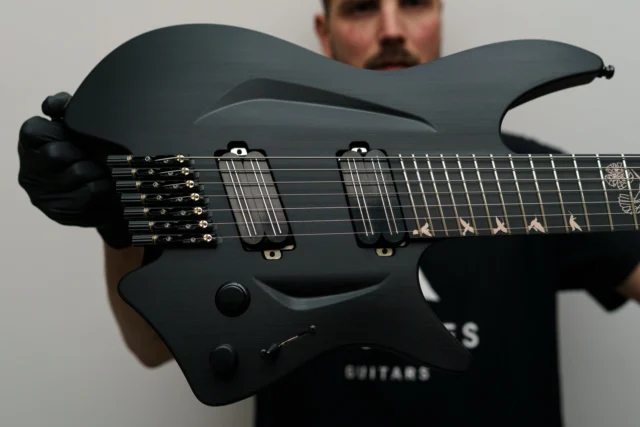 Aristides H/07R Black equipped with @bareknucklepickupsofficial Halcyons, an arcade killswitch and a beautiful geometric hummingbird inlay!