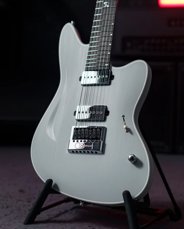 Aristides STX7R Light Grey featuring a faux white epoxy binding, @bareknucklepickupsofficial Stockholm bridge pickup and Supermassive neck, as well as an EverTune, and custom pearl tuner buttons!